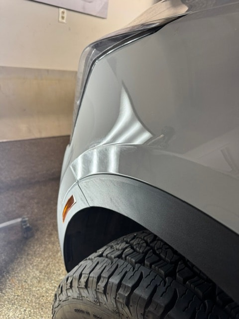 Silver truck fender smooth and restored after paintless dent repair