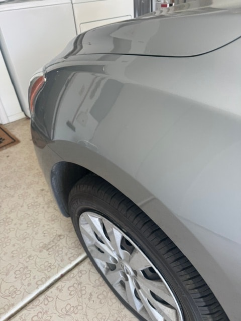 Gray car fender smooth and restored after paintless dent repair