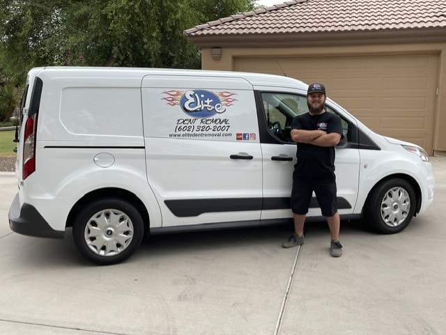 Elite Dent Removal technician standing next to branded white service van