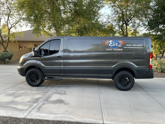 Elite Dent Removal dark branded Ford Transit van parked in driveway