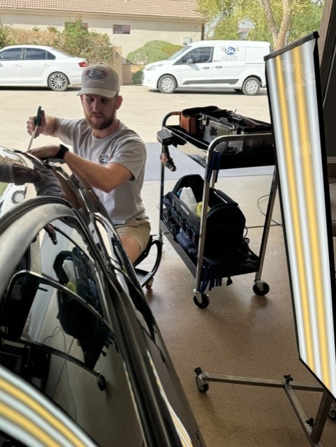 Elite Dent Removal technician performing paintless dent repair on a vehicle